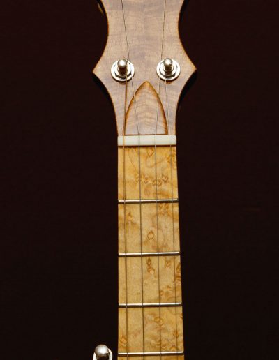 Birds Eye Maple Fingerboard with book matched Maple head cap laminate with ebony inlays